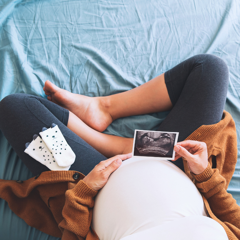 Pregnant woman looking at an ultrasound photo