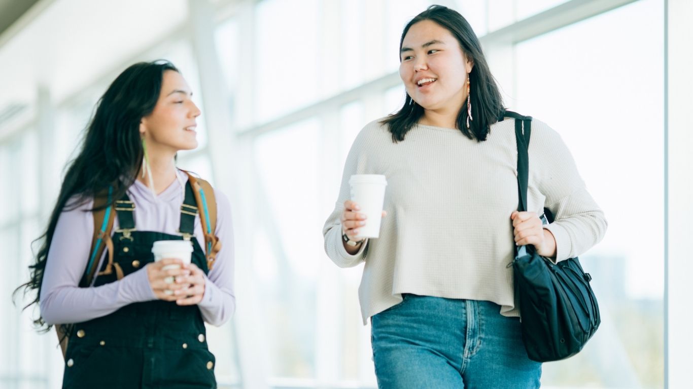Two students walking at UAA looking for support